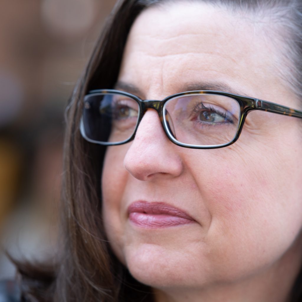 Headshot of Kathleen Fitzpatrick with glasses looking off into the distance